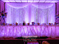 Led Curtain Backdrop with Purple Uplighting and Cinderella Skirting at Wellsburg Banquet Center